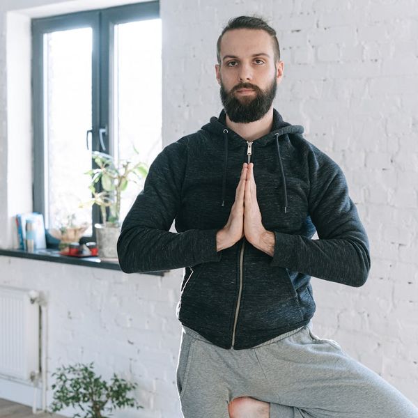 A calm and focused man meditating after a workout session.